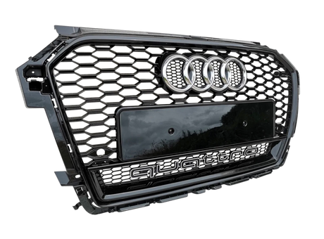 A car grille displays the Audi logo and "quattro" text in a hexagonal pattern with a glossy black finish, positioned against a light gray textured background.