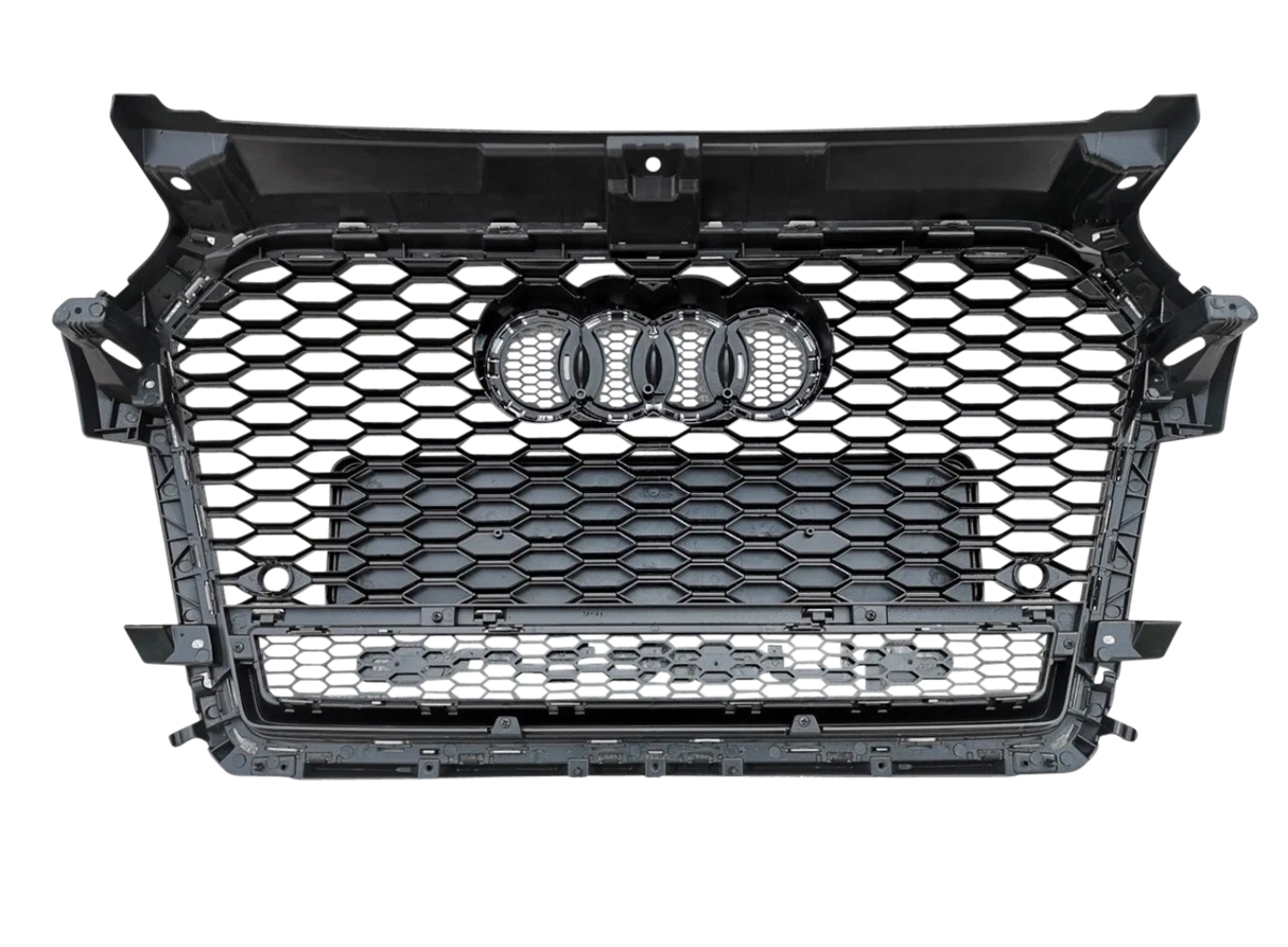 A black hexagonal-patterned car grille displays four rings at the center, set against a gray, seamless background.