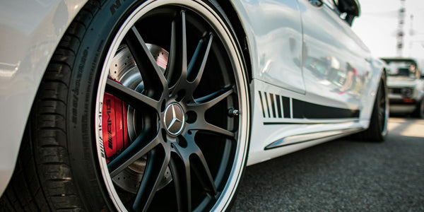 Photo by Aliaksei Semirski: https://www.pexels.com/photo/white-mercedes-benz-wheel-close-up-photo-13972881/