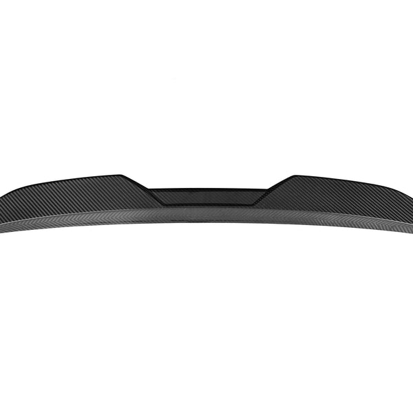 A sleek carbon fiber car spoiler sits against a white background, with a curved and aerodynamic design, featuring angular edges and textured surface details.