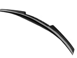 A sleek, curved black spoiler with a carbon fiber texture rests in isolation against a plain white background.