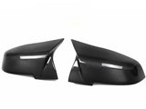 Two carbon fiber car mirror covers are positioned symmetrically against a white background, displaying a sleek, glossy finish with a visible weave pattern.