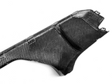 Carbon fiber cover with textured pattern, featuring angled sections and small brackets, positioned on a white background.