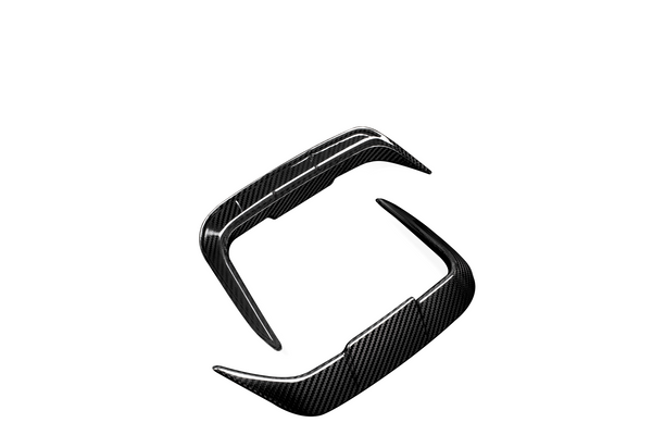 Carbon fiber car parts, specifically a spoiler enhancement kit, are positioned floating against a white background, showcasing their sleek, aerodynamic design and textured surface.