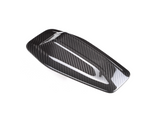 A sleek, carbon fiber car side mirror cover with a glossy finish, resting against a plain white background, highlighting its aerodynamic design and textured pattern.