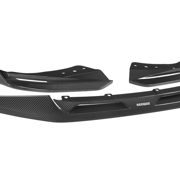 Black carbon fiber car bumper with aerodynamic design, composed of three parts. Positioned against a white background, the text reads "SODQOO" on the central piece.