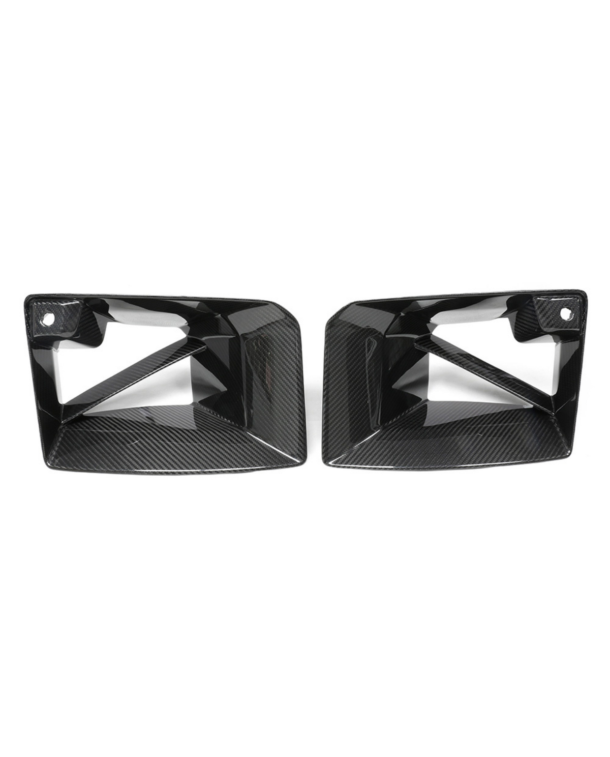 Two black, angular, carbon-fiber car exhaust trims with cutout designs are placed side by side against a plain white background.