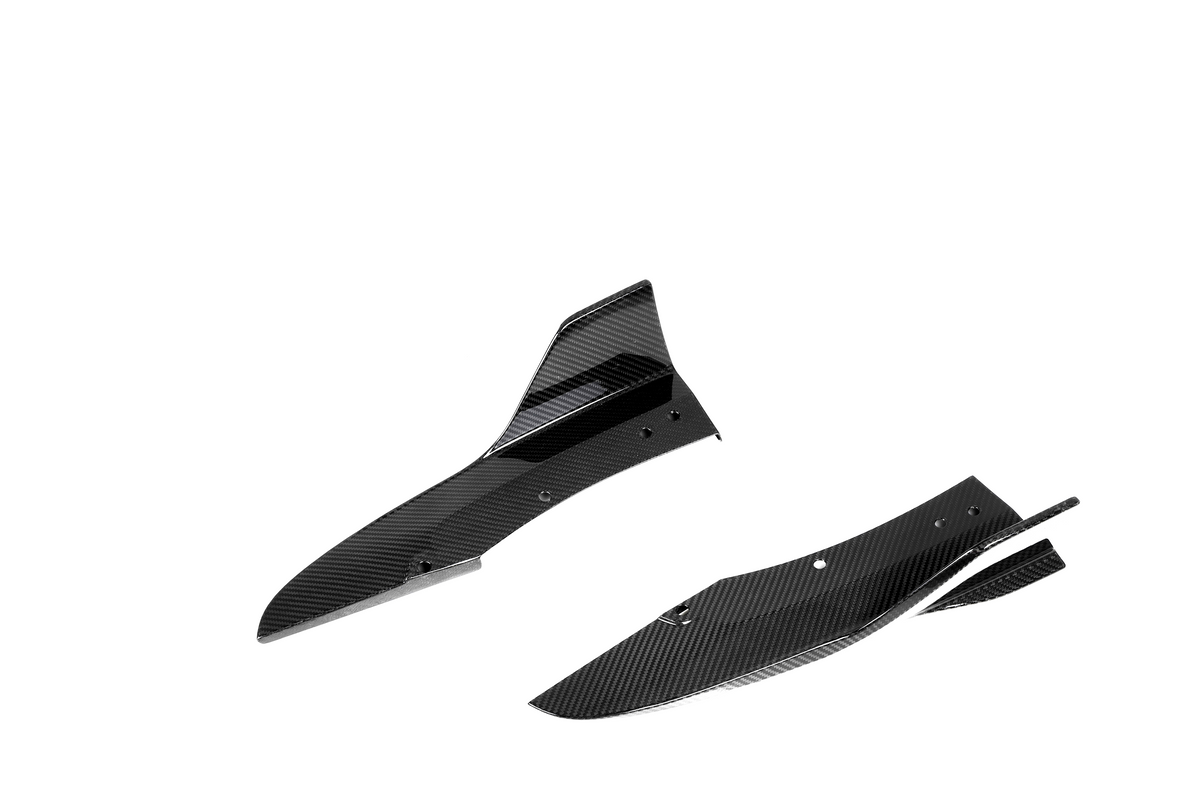 Two black carbon fiber car components are shown, featuring streamlined curves and holes for attachment, set against a plain white background.