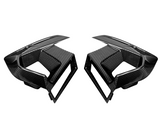 Two black carbon fiber car air vents, styled with sleek lines and sharp angles, face each other on a plain white background.