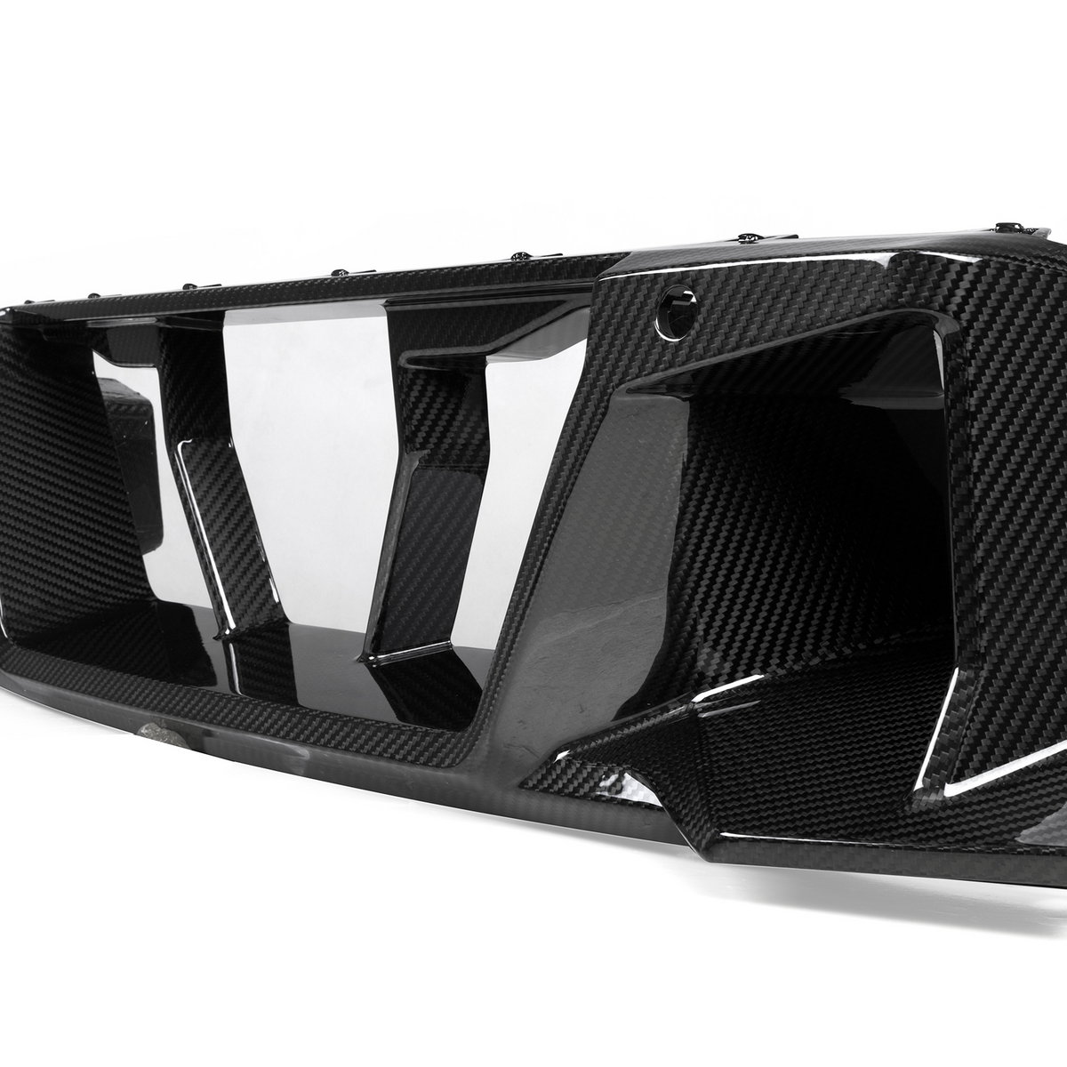 A carbon fiber car grille with angular vents is displayed on a plain white background, showcasing its glossy texture and intricate design.