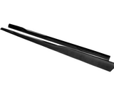 Two elongated, black carbon fiber car-side skirts lay parallel on a white surface, emphasizing their sleek, aerodynamic design.