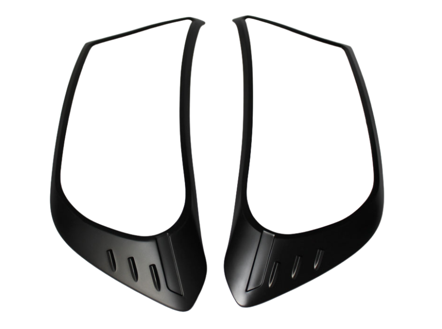 Two black plastic panels with angular contours and small vertical slits are displayed on a white background, facing each other symmetrically.