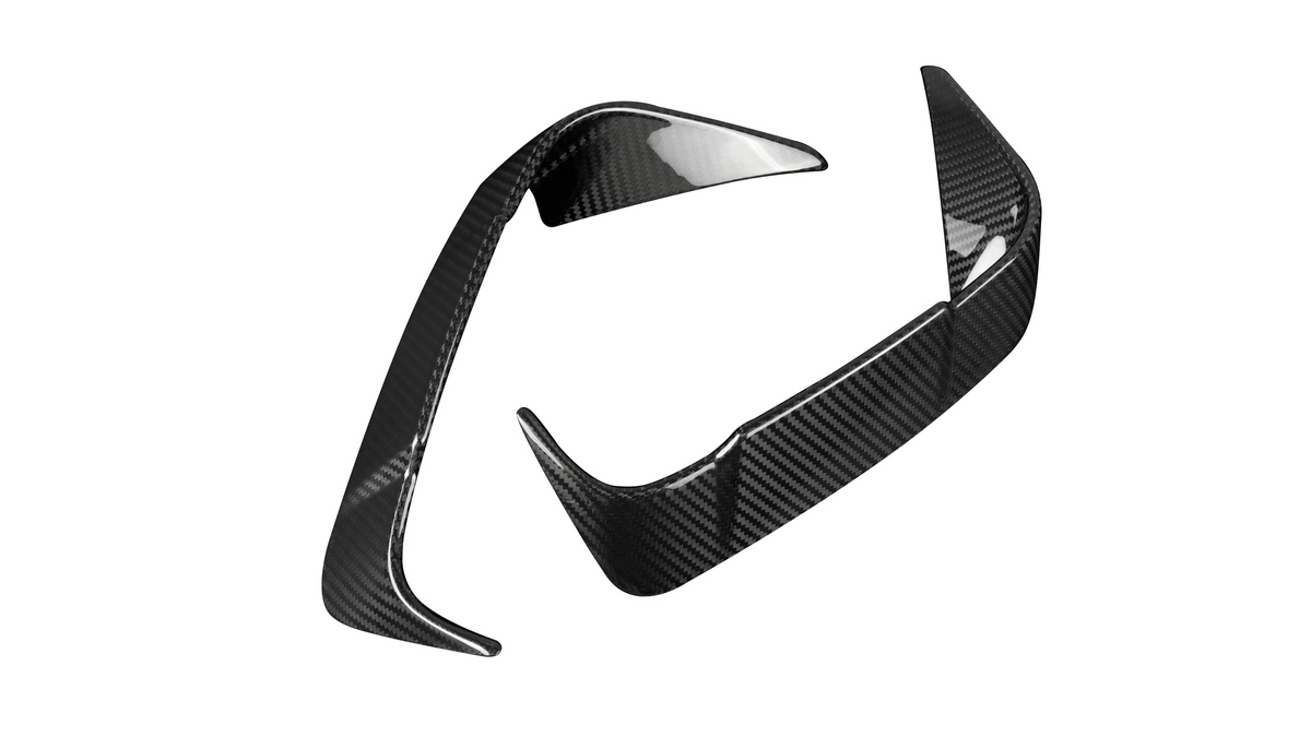 Two carbon fiber car parts with a sleek, aerodynamic design are positioned against a plain white background, displaying a glossy, reflective surface pattern.