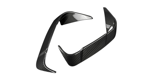 Two carbon fiber car parts with a sleek, aerodynamic design are positioned against a plain white background, displaying a glossy, reflective surface pattern.