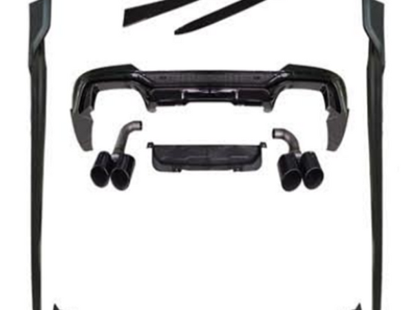 A set of black car body kit components, including bumpers, side skirts, and exhaust tips, are arranged on a white background, showcasing various parts for vehicle customization.