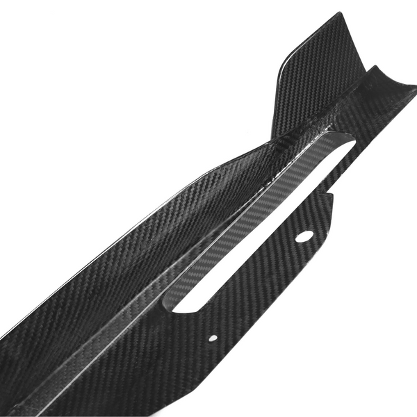 Carbon fiber car part features a sleek, angular design with cutouts and protrusions, set against a plain white background, suggesting high-performance automotive application.
