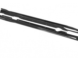 Carbon fiber car side skirts rest on a white surface. The upper skirt is slightly elevated, while the lower one is flat. The label reads 