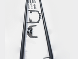 Two black metal sidebars with mounting brackets and assorted screws are laid out on a white surface, forming a complete set for vehicle installation.