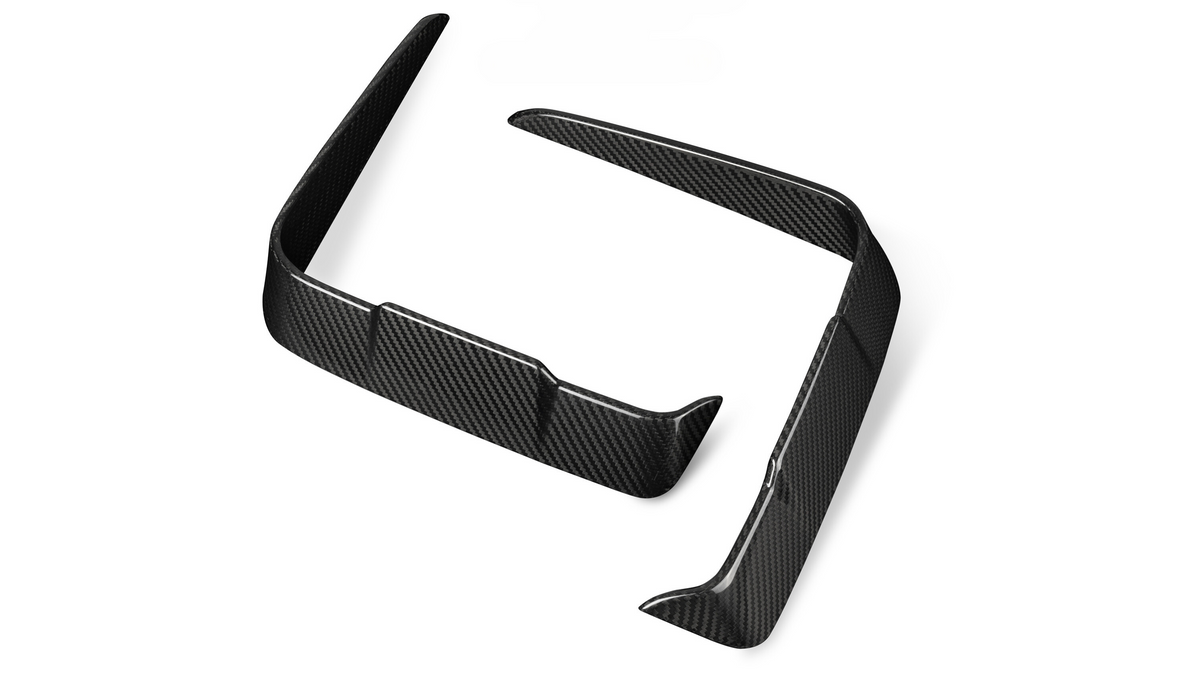 Two black carbon fiber car splitters are positioned on a plain white background, showcasing their glossy surface and aerodynamic design features.