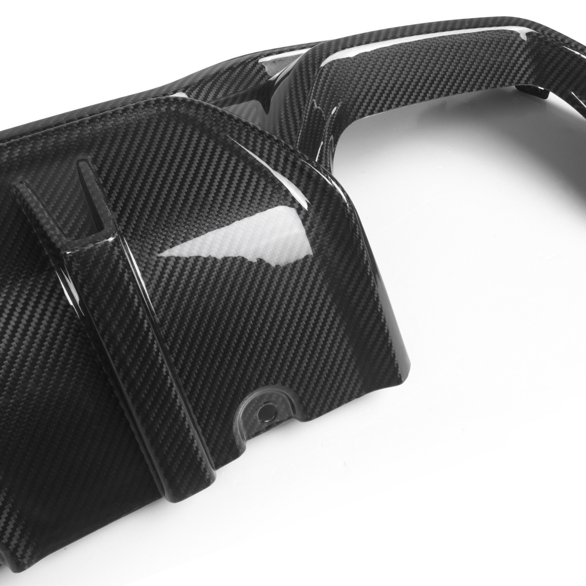 A carbon fiber car engine cover featuring sleek, curved design elements. It rests on a white background, exhibiting light reflections highlighting its glossy, textured surface.