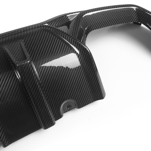 A carbon fiber car engine cover featuring sleek, curved design elements. It rests on a white background, exhibiting light reflections highlighting its glossy, textured surface.