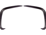 Two curved carbon fiber pieces form an arch-like shape, positioned symmetrically on a white background. They appear sleek and aerodynamically designed.