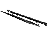 Two elongated, black carbon fiber side skirts with mounting brackets lie parallel on a plain white background, designed for automotive use, enhancing aerodynamic performance.