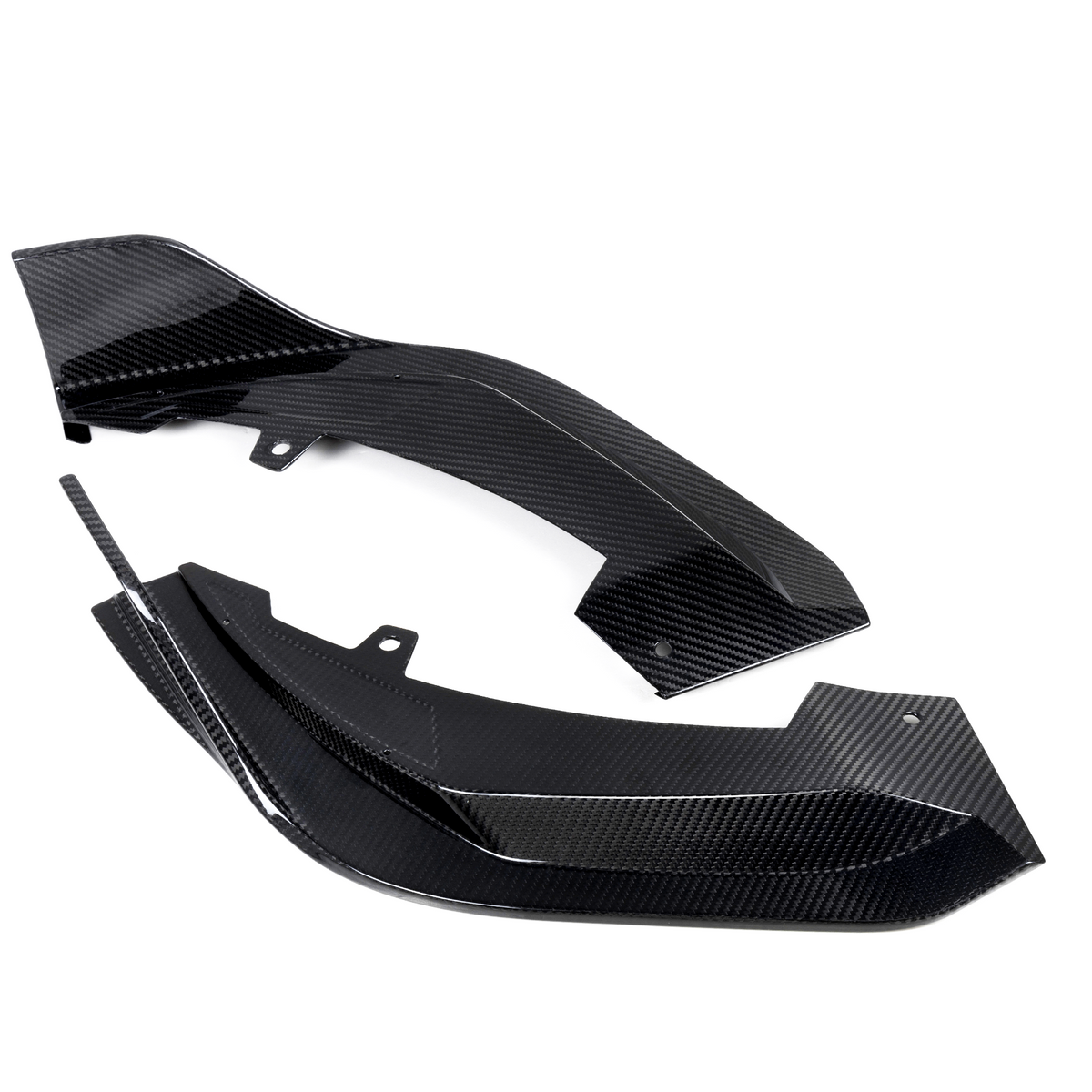 Two black carbon fiber components rest on a white background, featuring a glossy, textured surface with angular edges and mounting holes, suggesting automotive or aeronautical applications.