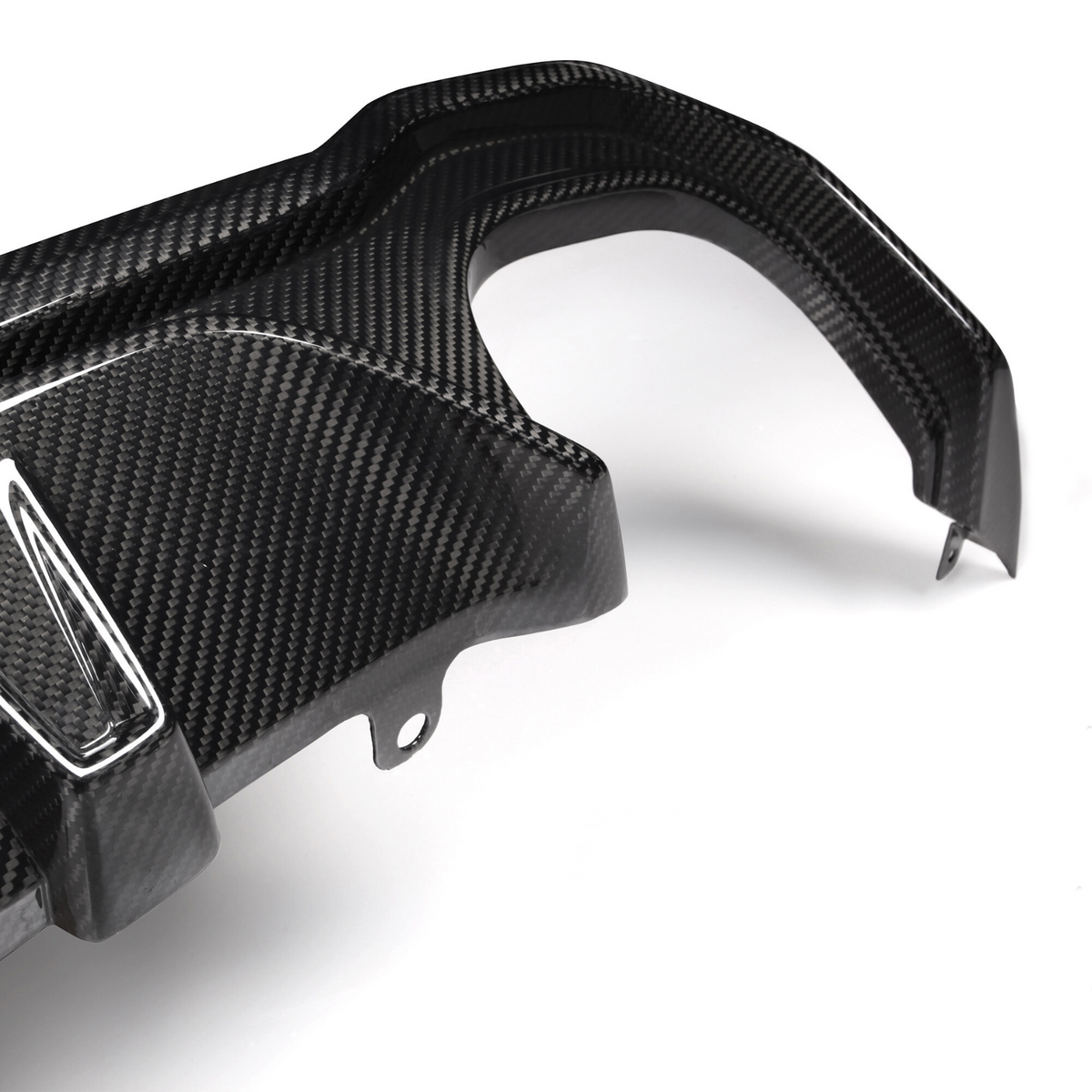A carbon fiber car part with angled attachments lies on a plain white background, showcasing its textured surface and precision design.