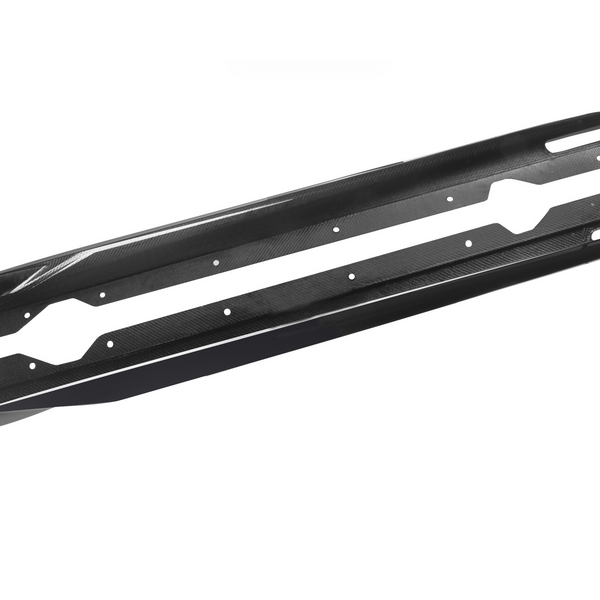 Two long, narrow, black carbon fiber side skirts with bolt holes lie parallel on a white background, designed for vehicle performance and aerodynamics enhancement.