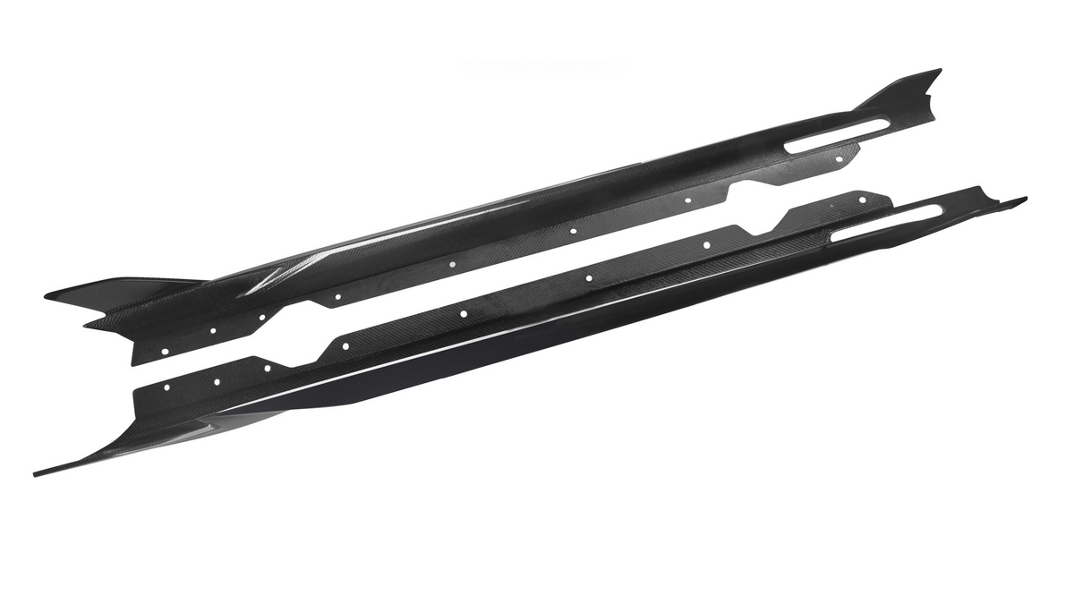 Two long, narrow, black carbon fiber side skirts with bolt holes lie parallel on a white background, designed for vehicle performance and aerodynamics enhancement.