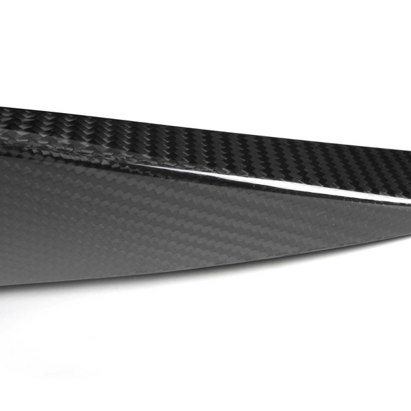 A sleek, black carbon fiber piece with a glossy finish; it has a pointed edge and diagonal patterning, set against a plain white background.