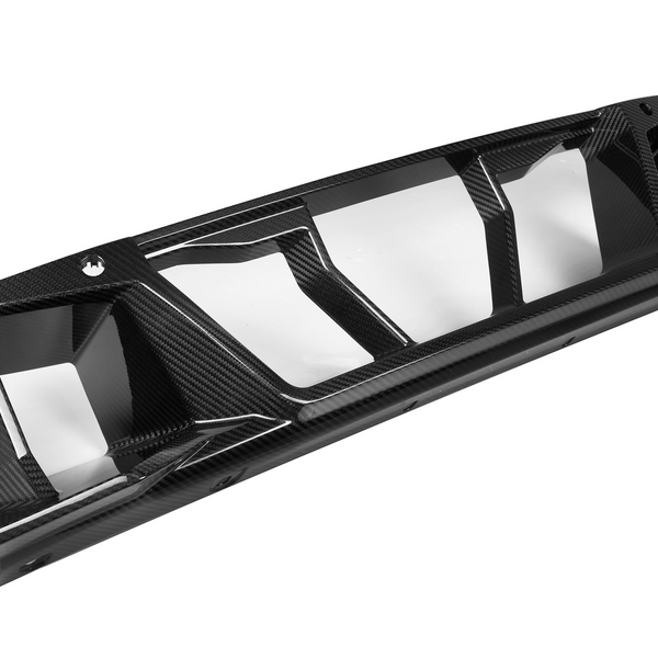 A black, carbon fiber car diffuser with sleek, angular fins designed for aerodynamic performance, placed on a plain white background.