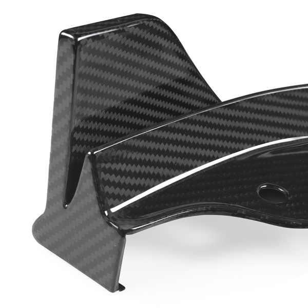 A glossy carbon fiber component with a textured pattern, featuring a curved design and a circular hole, rests against a white background.