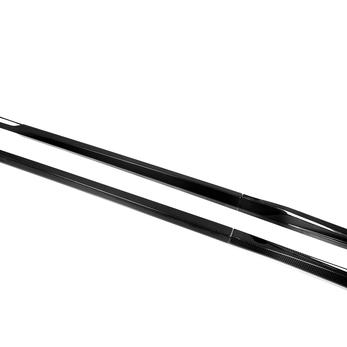 Two sleek, black carbon fiber side skirts lie parallel on a white background, showcasing a streamlined design with smooth, reflective surfaces and tapering ends.