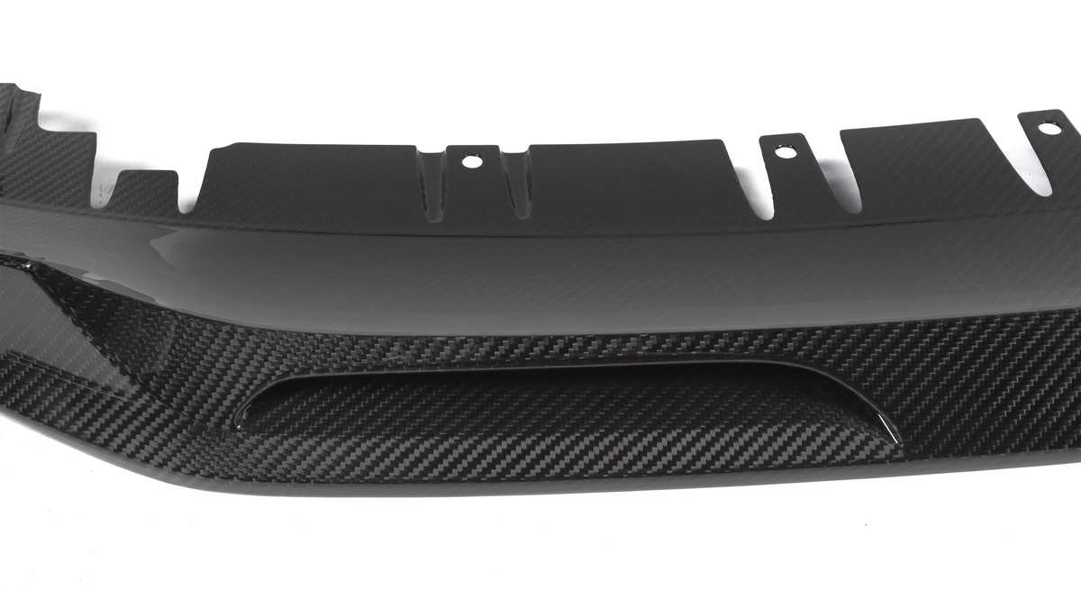 A carbon fiber car diffuser with a sleek, aerodynamic design features curved fins and vent openings, set against a plain white background.