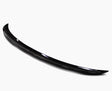 A sleek, black car spoiler with a smooth, curved design rests on a plain white background, highlighting its glossy finish and aerodynamic shape.