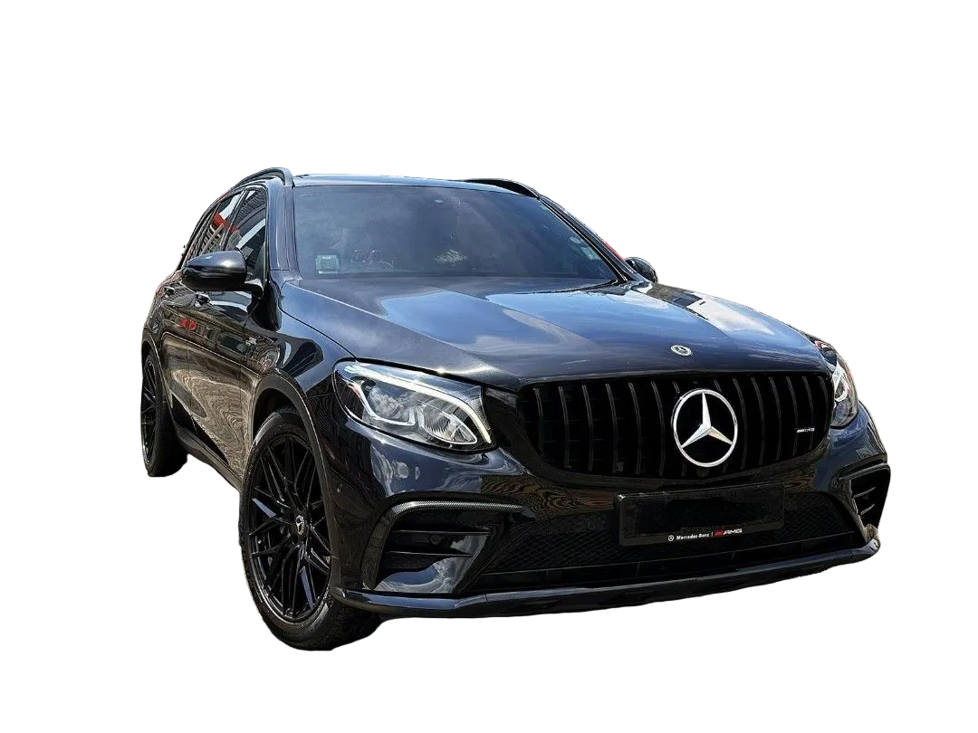 A black Mercedes-Benz SUV is parked on a rooftop, surrounded by Singapore city skyscrapers and red flags. The grill features the Mercedes logo prominently.