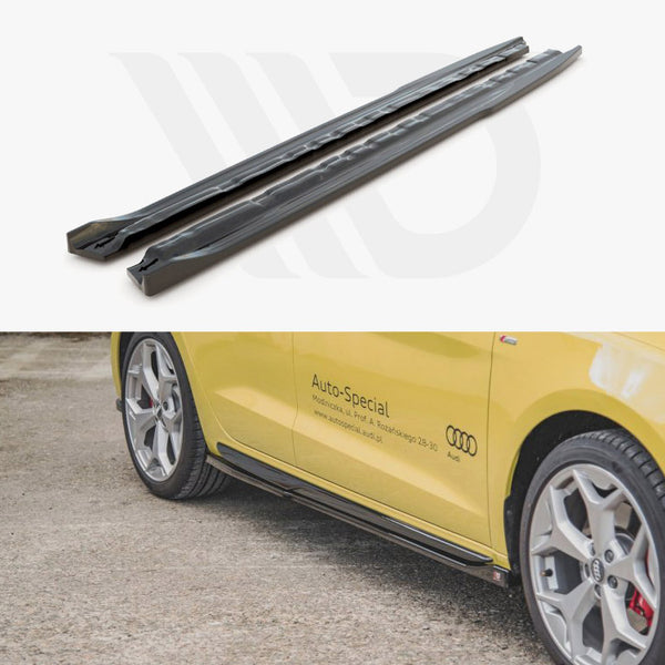 Two black car side skirts are displayed above a yellow Audi with silver wheels parked on gravel. The car has "Auto-Special" text and a website, www.auto-specialaudi.pl, on the side.