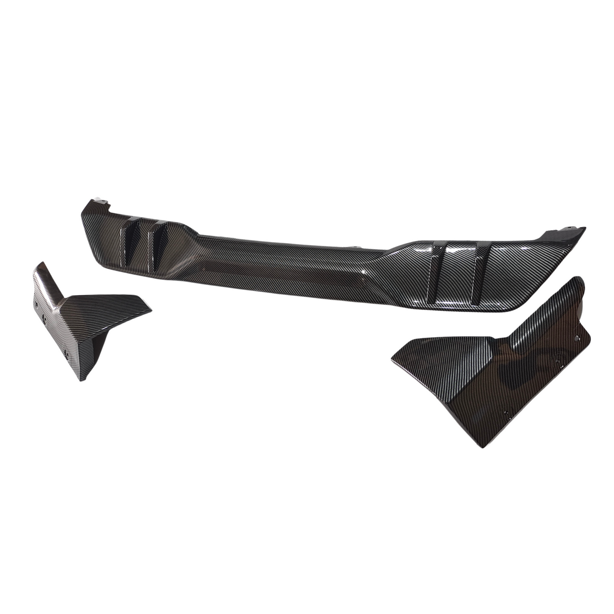 Carbon fiber car parts displayed: a long, textured rear diffuser with aerodynamic fins and two side winglets, set against a plain white background.