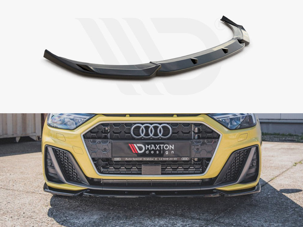 Car front splitter positioned above, installed on the yellow car’s front bumper below. Bumper displays the logo “Maxton Design” and contact details, set outdoors on a paved surface.