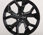 A glossy black alloy wheel with a five-spoke design featuring the Audi logo at the center, sits against a plain white background.