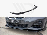 A black car front lip spoiler is shown above its installation on a gray car with a 