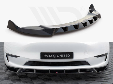 Aerodynamic car bumper extension with a sleek, black finish; installed on a white vehicle's front, which is parked on a checkered surface. License plate reads "#MAXTONIZED."