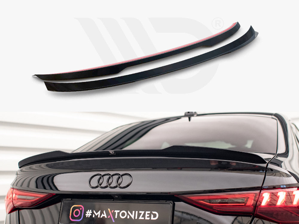Two black car spoilers sit on a plain background above a black Audi with one spoiler installed on the trunk. License plate reads: "#MAXTONIZED".