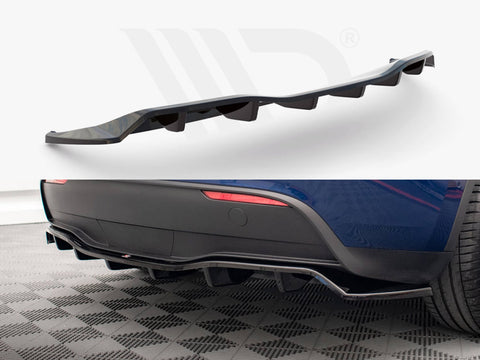 Curved black car diffuser, with angled fins, is displayed against a white backdrop and attached under the rear of a blue car, highlighting its sporty aesthetic on a checkered floor.