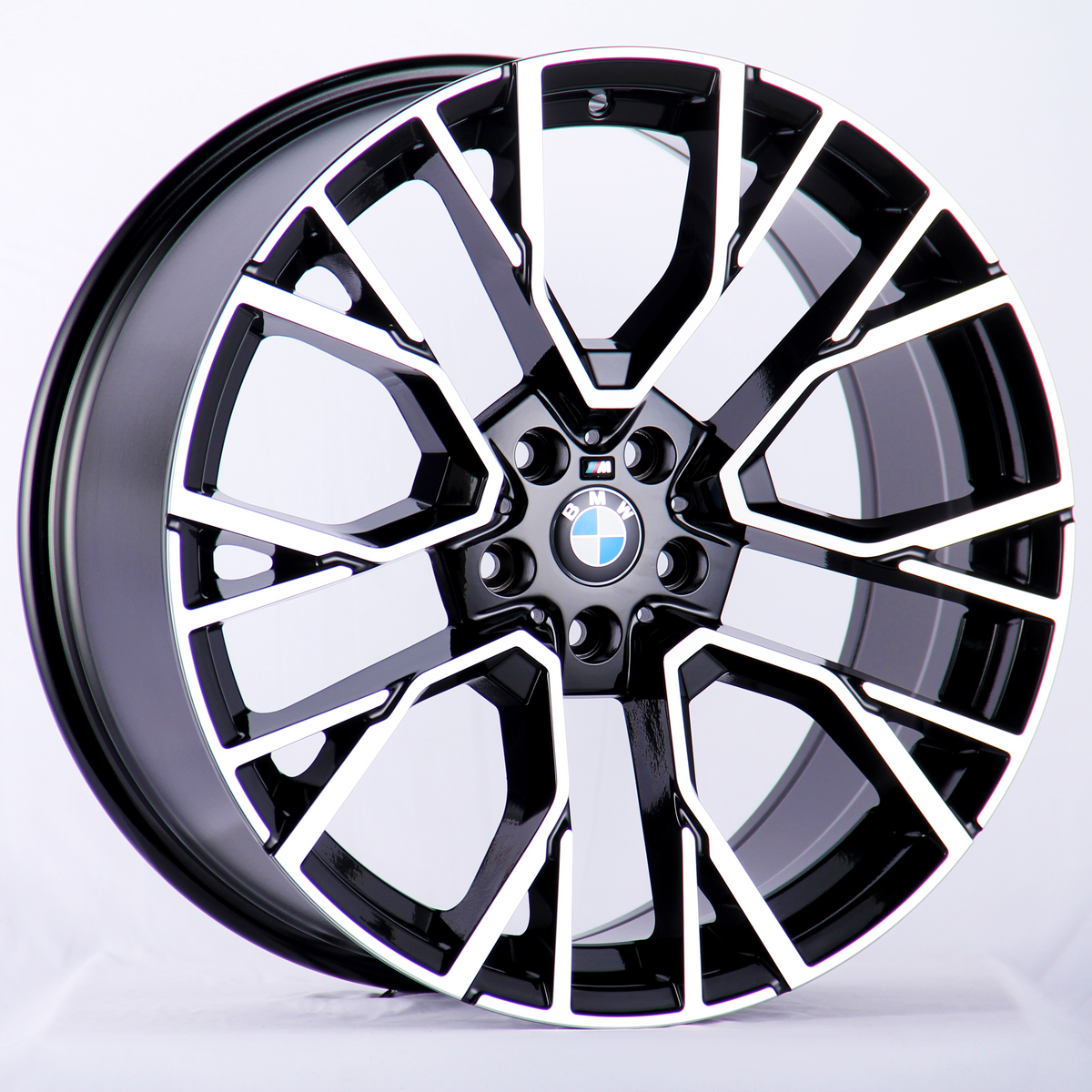 A sleek, black and silver alloy wheel with a BMW logo in the center, prominently displayed against a plain white background.