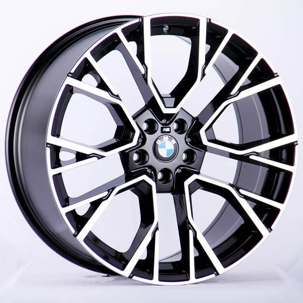 A sleek, black and silver alloy wheel with a BMW logo in the center, prominently displayed against a plain white background.