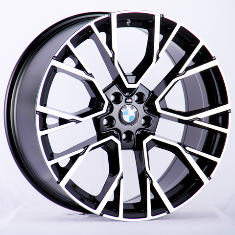 A sleek, black and silver alloy wheel with a BMW logo in the center, prominently displayed against a plain white background.