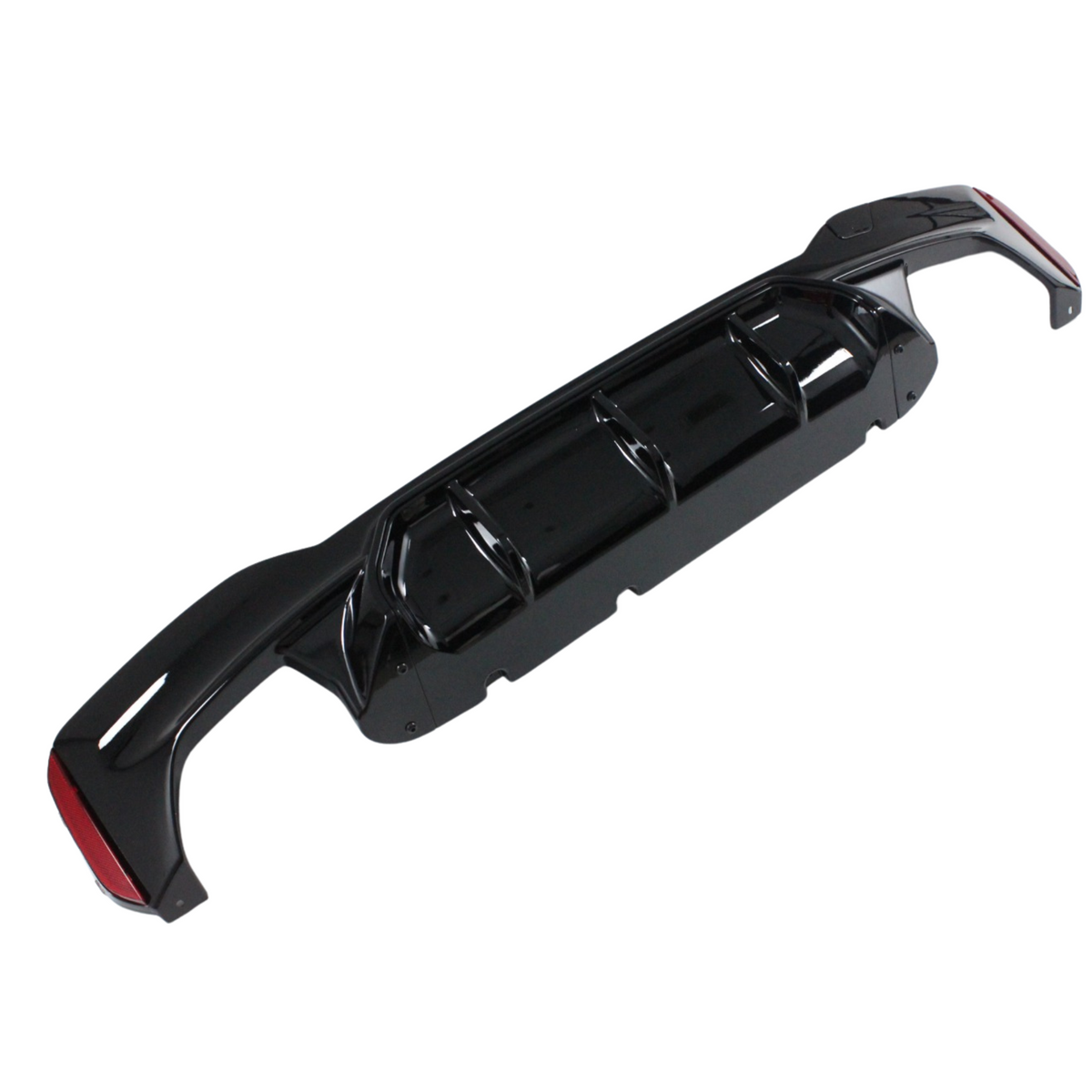 A black car bumper diffuser, positioned horizontally, features multiple aerodynamic fins and red reflective accents on a plain white background.